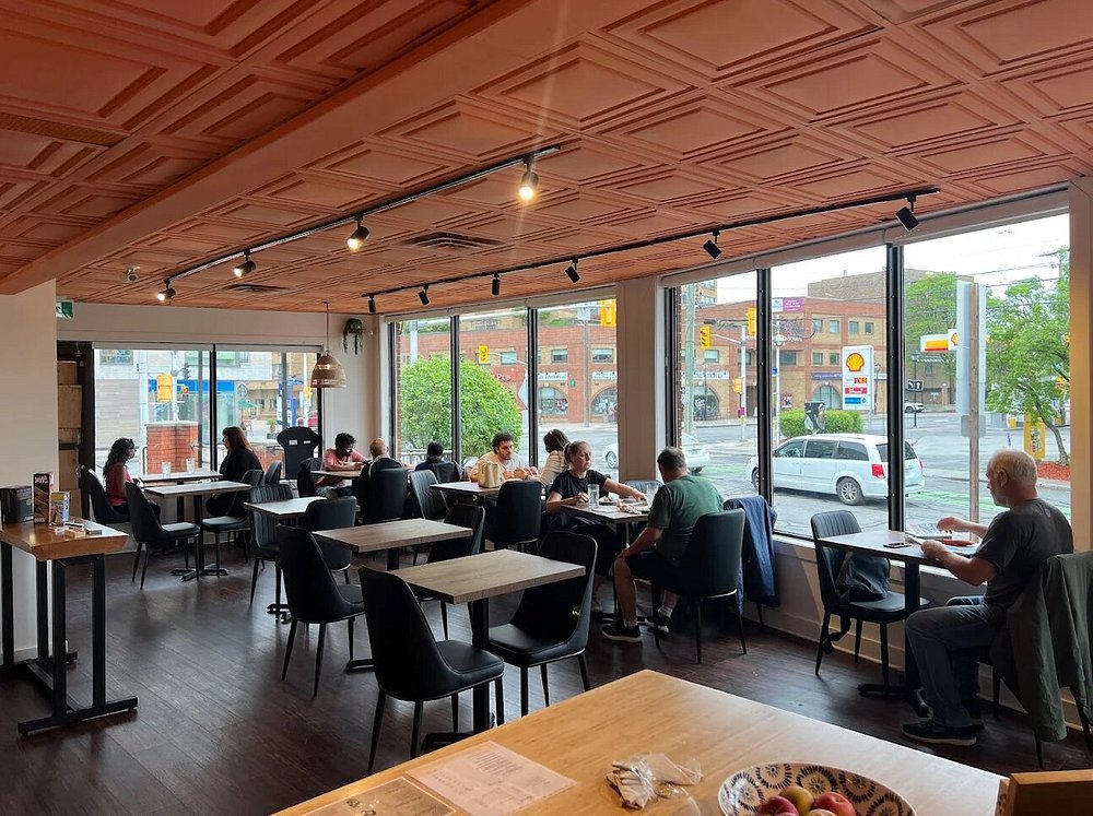 Sachi's Cafe-Bistro interior with customers enjoying the warm atmosphere and big windows